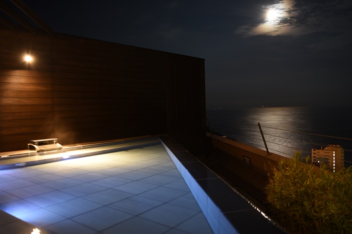 天空露天風呂から眺める満月とムーンロード